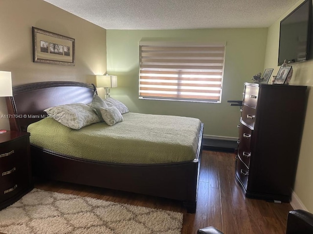 bedroom with hardwood / wood-style flooring and a textured ceiling