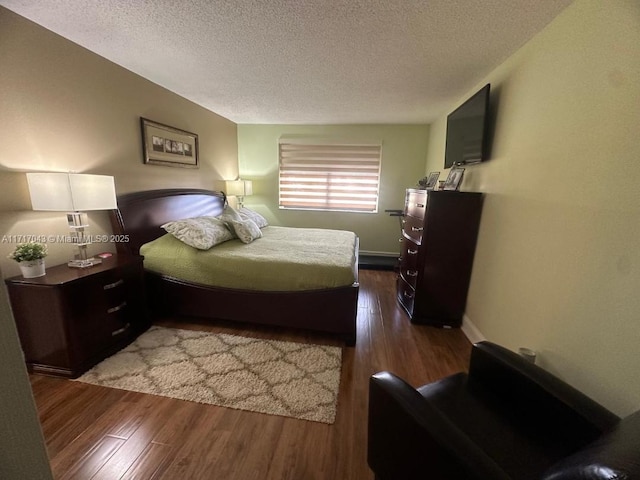 bedroom featuring a textured ceiling and dark hardwood / wood-style floors