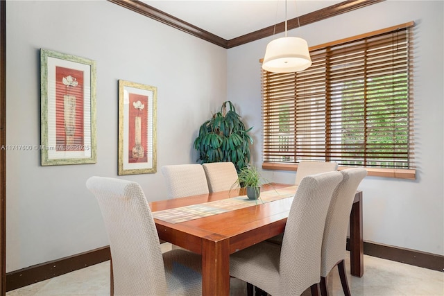 dining space featuring crown molding