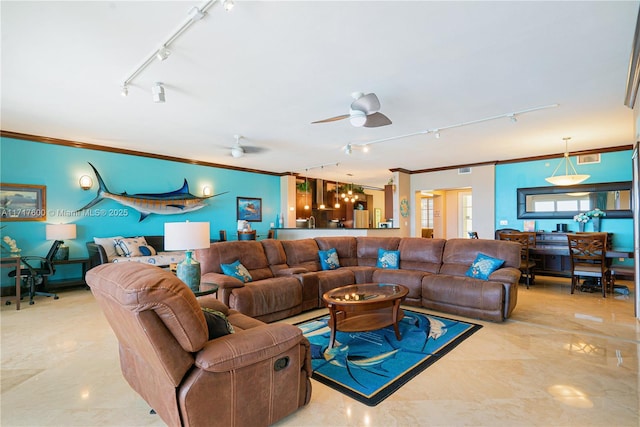 living room with ceiling fan and ornamental molding