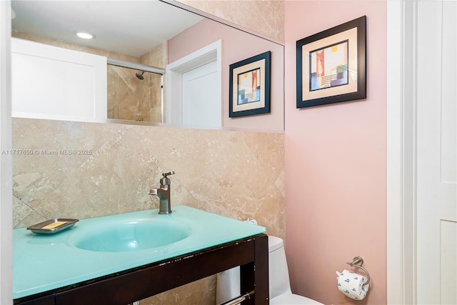 bathroom with vanity, toilet, and walk in shower