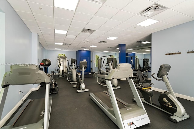 exercise room with a paneled ceiling