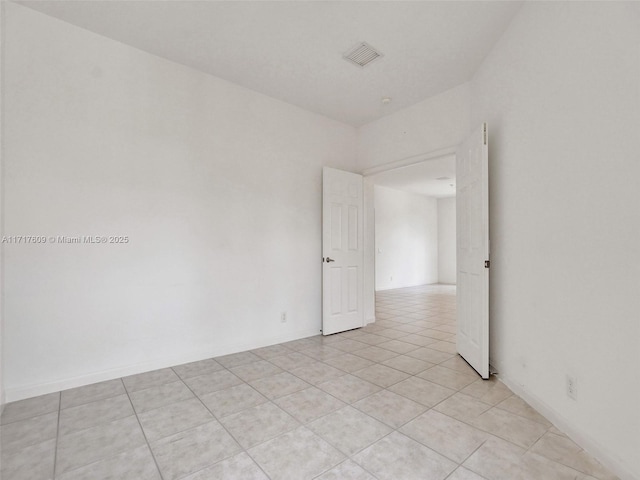 empty room with light tile patterned floors