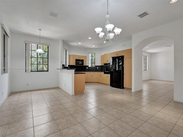 kitchen featuring hanging light fixtures, black appliances, light brown cabinetry, kitchen peninsula, and a chandelier