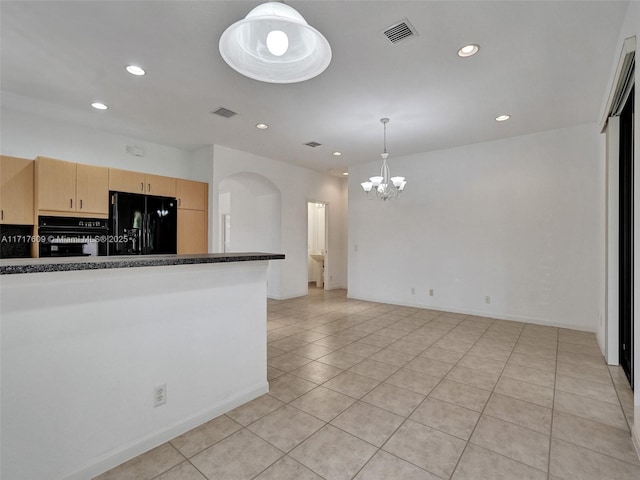 kitchen with a chandelier, hanging light fixtures, light tile patterned floors, light brown cabinets, and black appliances