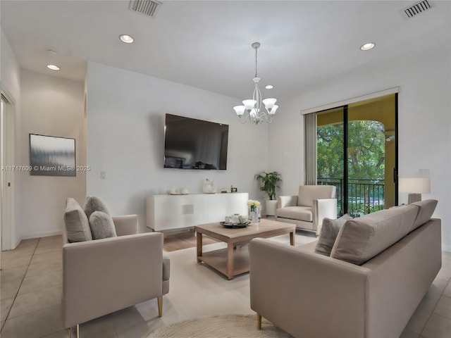 living room featuring a notable chandelier and light tile patterned floors