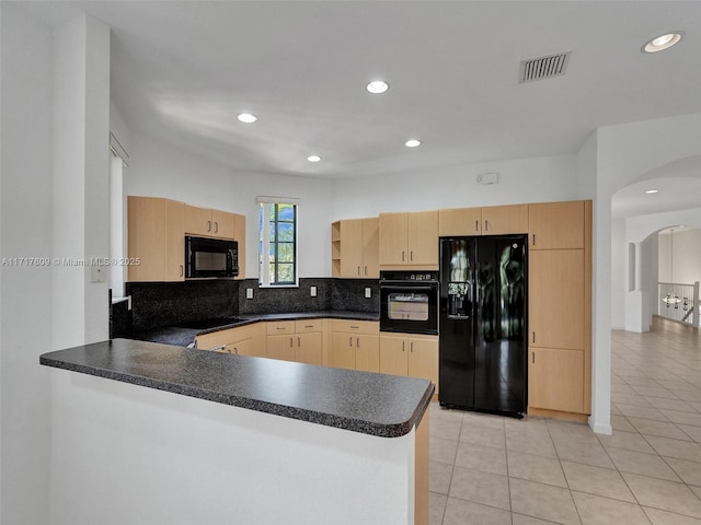 kitchen with light brown cabinetry, black appliances, kitchen peninsula, and light tile patterned flooring