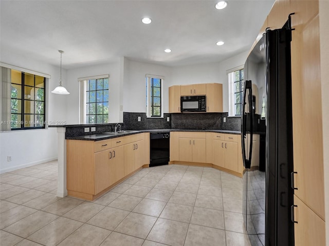 kitchen with light tile patterned floors, black appliances, light brown cabinetry, decorative light fixtures, and kitchen peninsula