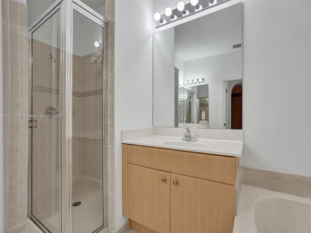 bathroom with vanity and separate shower and tub