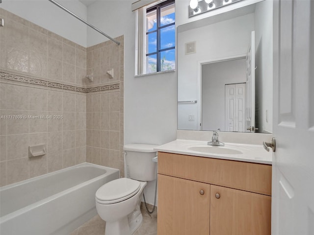 full bathroom featuring tile patterned flooring, vanity, tiled shower / bath combo, and toilet