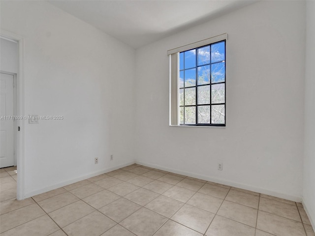 unfurnished room featuring light tile patterned floors