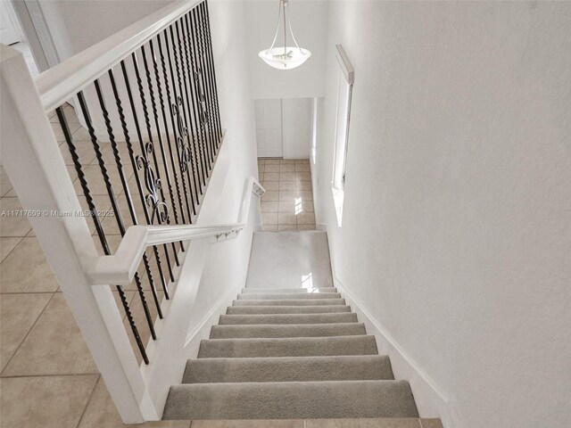 stairs with tile patterned floors