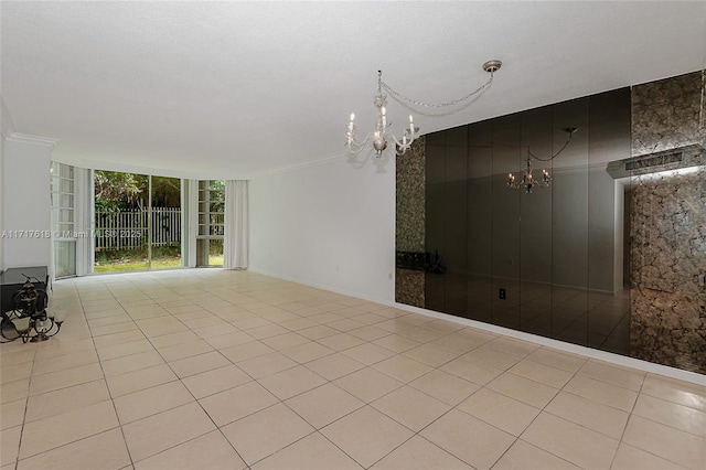 empty room with ornamental molding and light tile patterned flooring