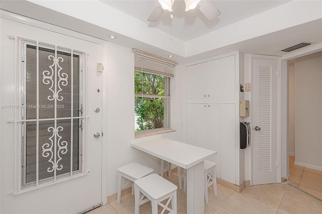 interior space with ceiling fan and light tile patterned flooring