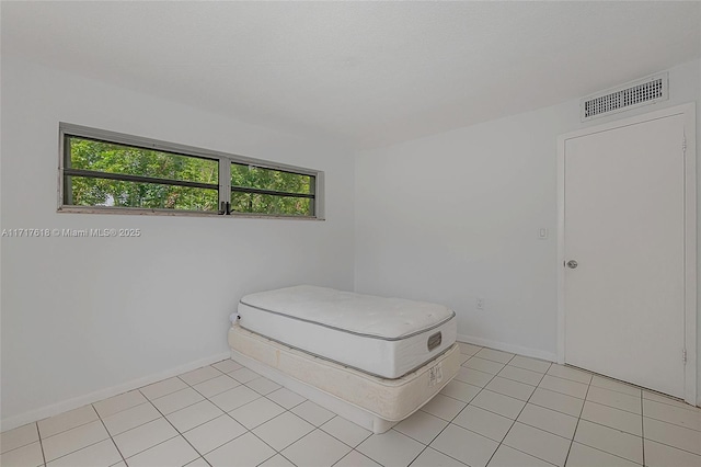 bedroom with light tile patterned floors