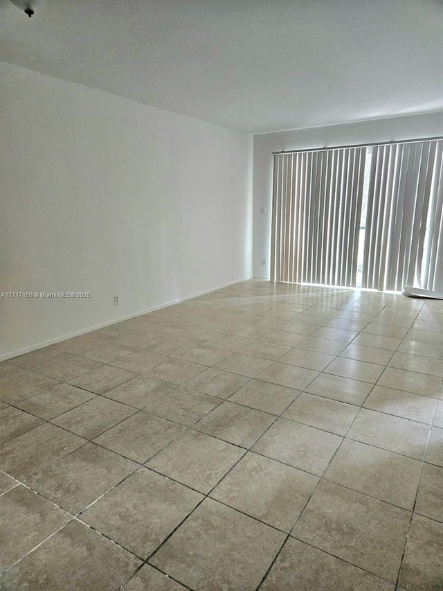 spare room with light tile patterned floors