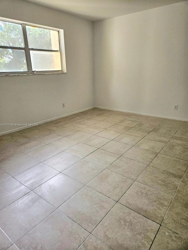 empty room with light tile patterned floors