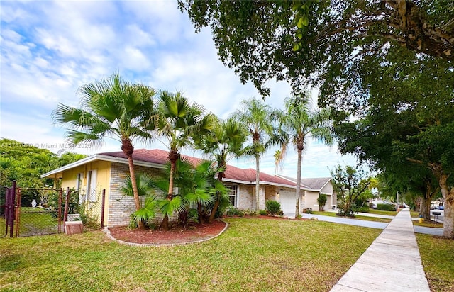 view of side of property featuring a lawn and a garage