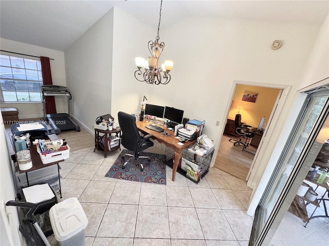 tiled office with lofted ceiling and an inviting chandelier