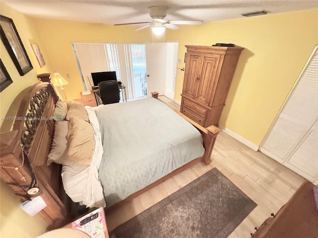 bedroom with hardwood / wood-style floors and ceiling fan