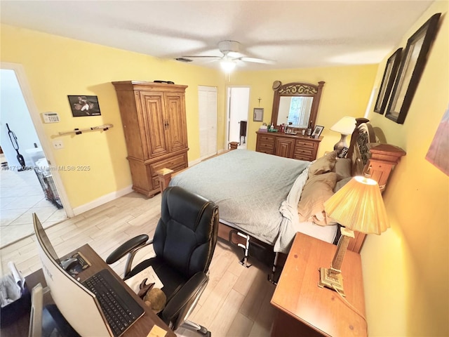 bedroom with ceiling fan and light hardwood / wood-style flooring