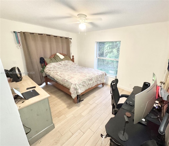 bedroom featuring hardwood / wood-style floors, a textured ceiling, and ceiling fan