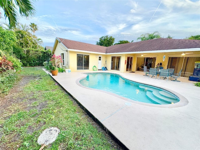 view of pool with a patio and ceiling fan