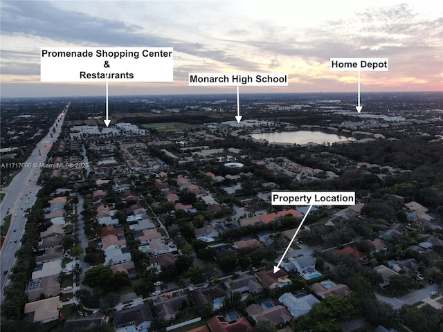 aerial view at dusk with a water view