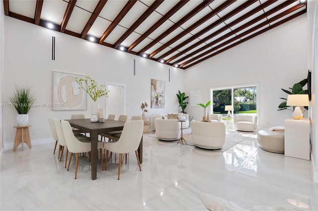 dining room featuring beamed ceiling and high vaulted ceiling