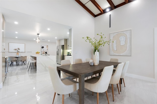 dining area with beamed ceiling and high vaulted ceiling