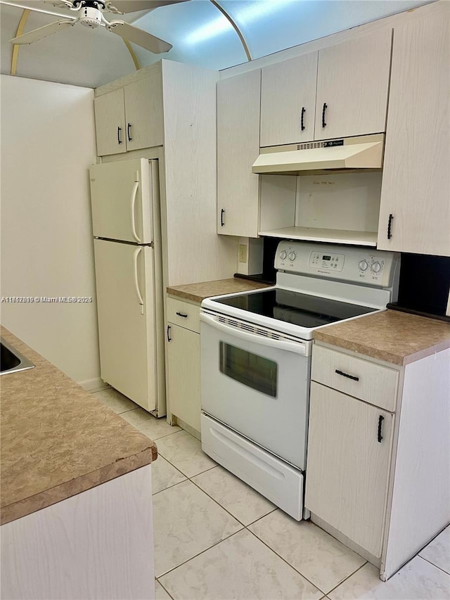 kitchen with white appliances, ceiling fan, and light tile patterned flooring