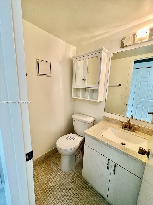 bathroom featuring vanity and toilet