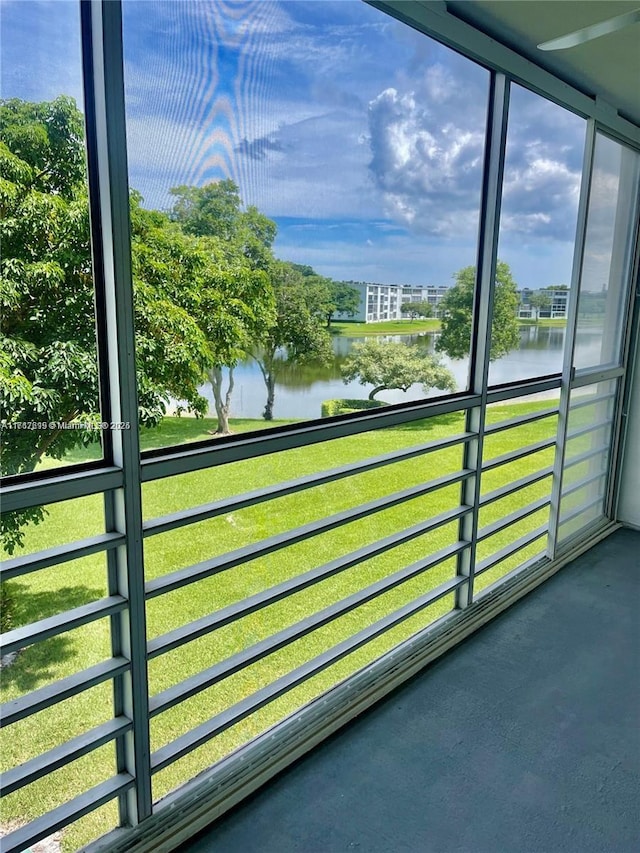 unfurnished sunroom with a water view