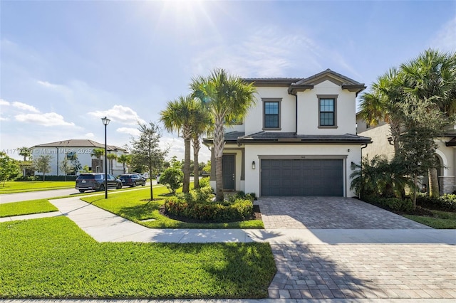 view of front of property featuring a front lawn and a garage