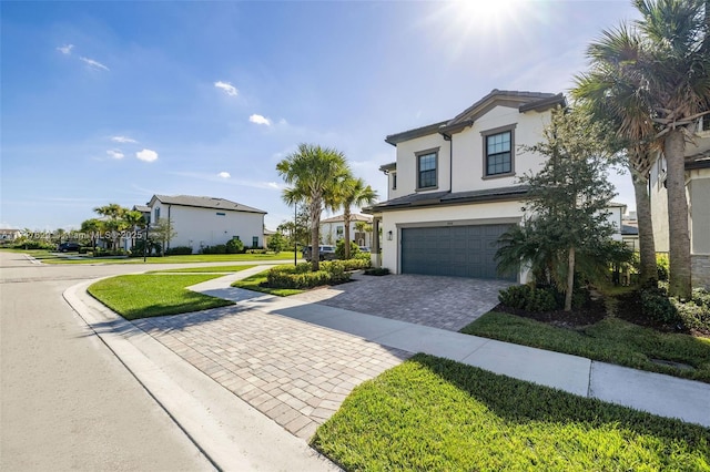 view of front facade featuring a front yard and a garage