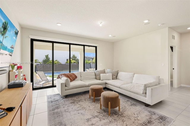 living room with light tile patterned floors and a textured ceiling