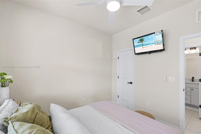 tiled bedroom with ensuite bathroom and ceiling fan