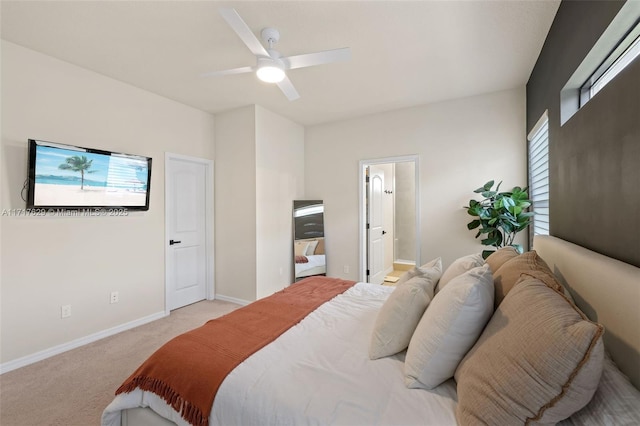 carpeted bedroom featuring ensuite bathroom and ceiling fan