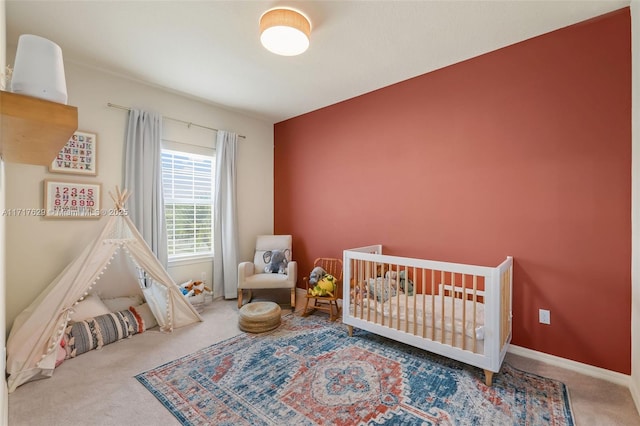 bedroom with carpet flooring and a crib