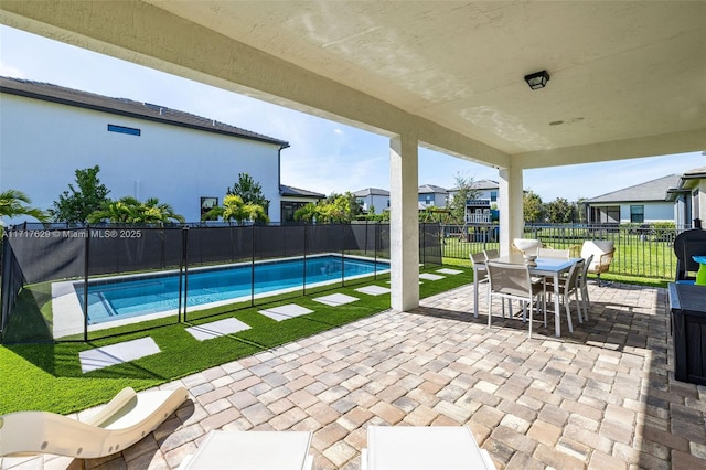 view of pool featuring a lawn and a patio