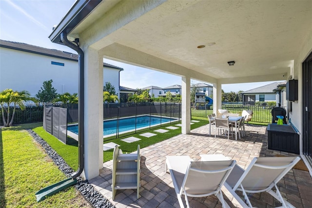 view of patio / terrace with a fenced in pool