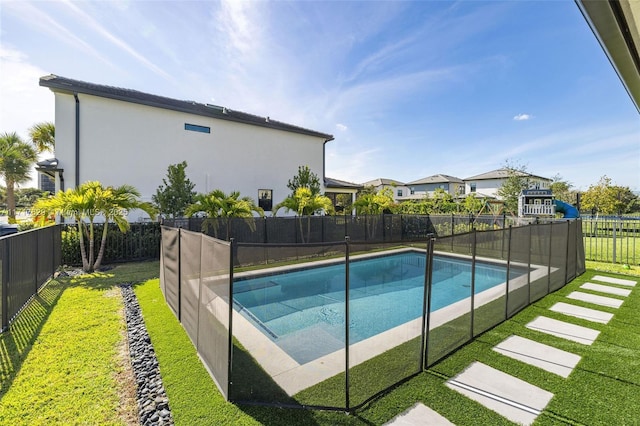 view of pool featuring a yard