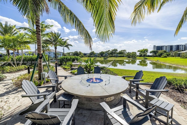 view of patio featuring a water view and an outdoor fire pit