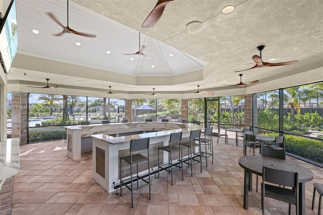 sunroom with a tray ceiling and wooden ceiling