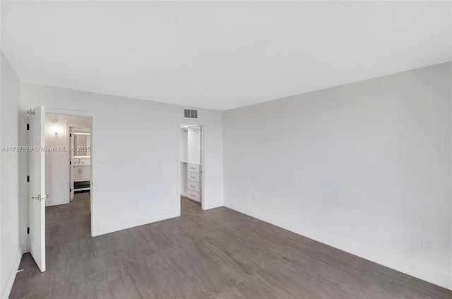 unfurnished bedroom featuring dark wood-type flooring