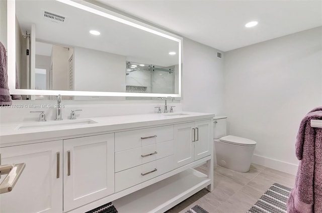 bathroom featuring vanity, toilet, and an enclosed shower