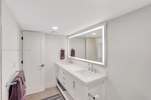 bathroom featuring vanity and wood-type flooring