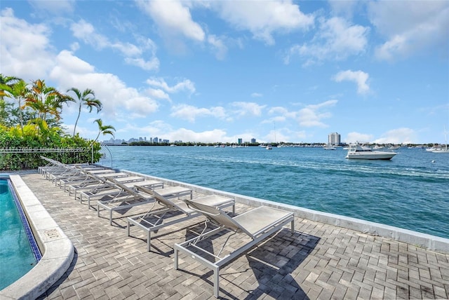 exterior space featuring a water view and a community pool