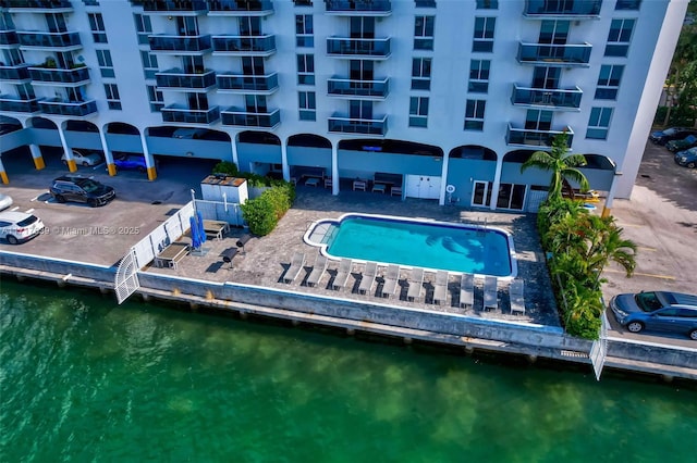 view of swimming pool with a water view