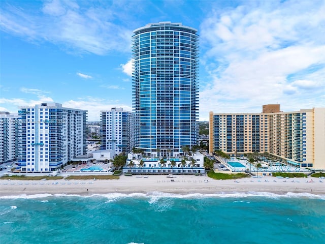 aerial view with a water view and a beach view